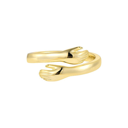 Vielring gold hug ring, adjustable sterling silver band designed as embracing hands.